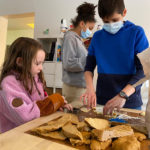 In Québec City, children and junior youth gather to bake a large quantity of cookies to distribute them to the less privileged ones in their town.