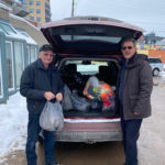 Two friends drop off community donations of socks and jackets at the Martha’s Table community centre.